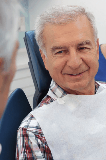 Man Smiling in dental chair | Indigo Dental Practice Jersey